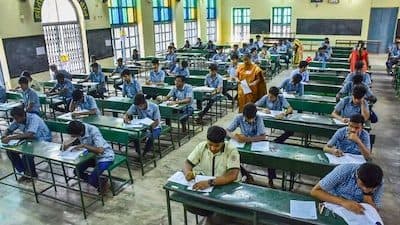 Students writing an examination in a school hall